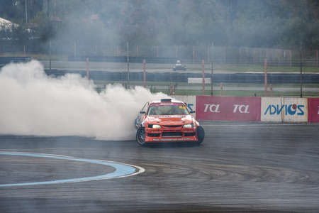 VLADIVOSTOK, RUSSIA - OCTOBER 02: Car drift, Sports car wheel drifts and a lot of smoke on the track. Russian drift show RDS without borders on October 02, 2021.のeditorial素材