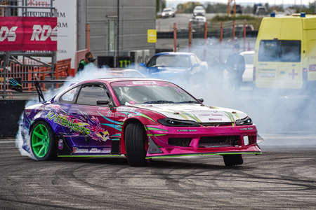 VLADIVOSTOK, RUSSIA - OCTOBER 02: Car drift, Sports car wheel drifts and a lot of smoke on the track. Russian drift show RDS without borders on October 02, 2021.のeditorial素材