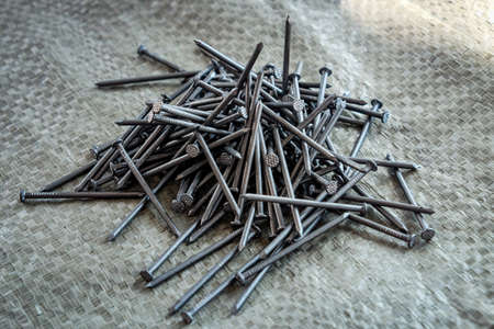 a large pile of nails on the table.の写真素材
