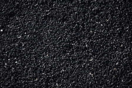 Texture of a rubber crumb for stadium. Rubber asphalt. Resilient coating for sports and athletics fields, jogging, running track and cycling paths.の写真素材