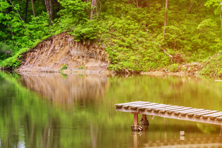 Old wooden pier on small country lake.の写真素材