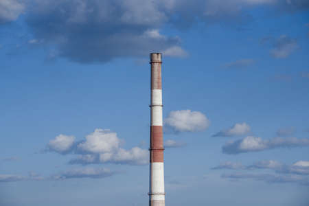 close-up factory brick chimney. pipe cogeneration plant on the sky background. Ambient air pollution...