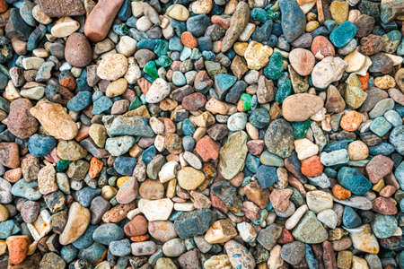 Lots of small colorful pebbles from the seashore.の写真素材
