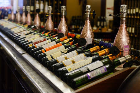 Moscow, Russia, August 2021: Wine bottles laid out in a row on a shelf in a store.のeditorial素材