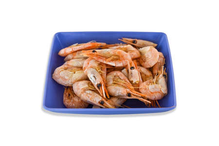 Cooked fresh shrimps on a blue plate isolated on white background. Seafood healthy food.の写真素材