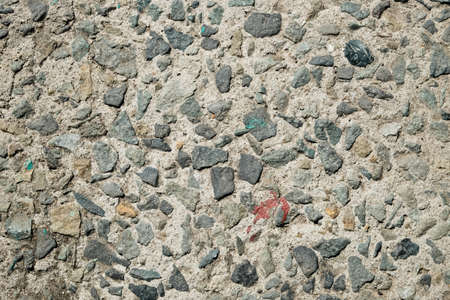 small pebbles in a cement floor. Shot from above.の写真素材