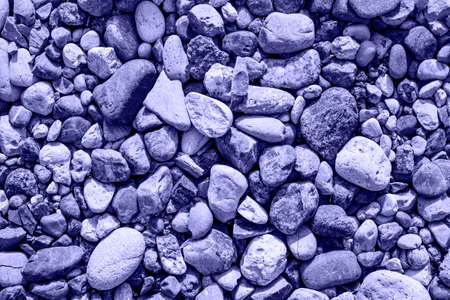 Abstract background texture, sea stones, pebble, top view. photo toned in the color of the year very...