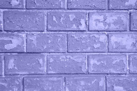 old brick wall with peeling paint texture grunge background. photo toned in the color of the year very periの写真素材
