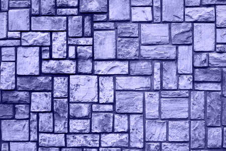 Texture of a stone wall. Stone wall as a background or texture. Part of a stone wall, for background or texture. photo toned in the color of the year very periの写真素材