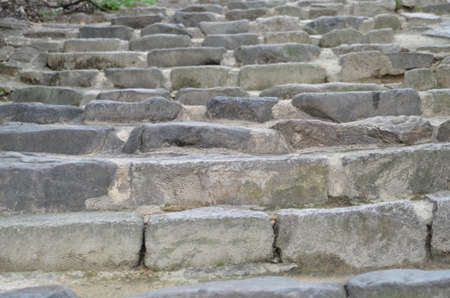 Old stone staircase, natural stone. Selective focus, close up.