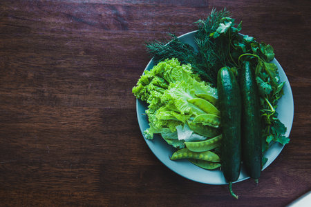 fresh cucumbers, lettuce, dill, cilantro and green peas. Spring salad, spring greens, healthy food from natural products. Vegetarian food. Vintage tone.の写真素材
