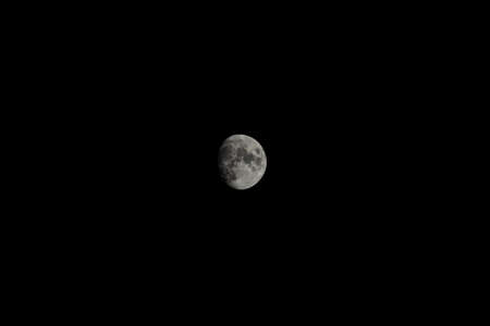 Moon isolated in dark night sky without visible stars.の写真素材