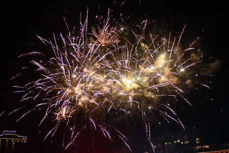 Festive beautiful fireworks at night over the city.