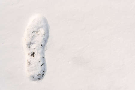 footprints on the snow under sunlight close-up with copy space.の写真素材