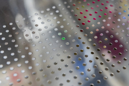 Metallic background with perforations of round holes.の写真素材