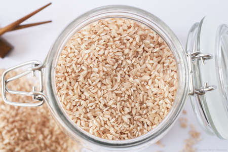 Pink rice in a glass jar with a rope lidの写真素材