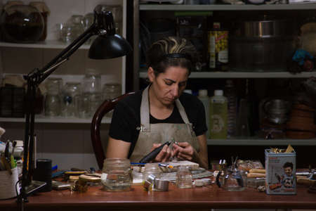 Woman working making jewelry in an artisanal way in her workshop in Bilbao, Vizcayaの写真素材