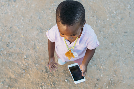 Black child with mobile phoneの写真素材