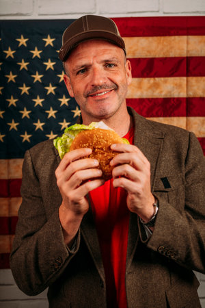 American man eating a hamburger.の写真素材