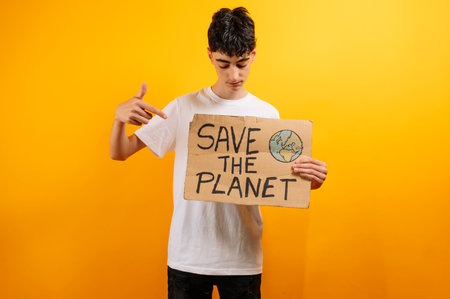 Young activist holding "Save the Planet" sign.の写真素材