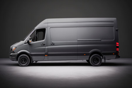 Dark gray cargo van. Isolated on gray studio background. side view.の素材