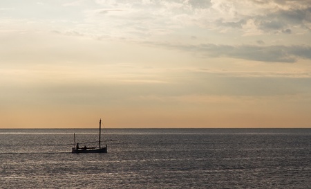 Sailboat at dawn, taken from Barcelona on the Mediterranean sea.の写真素材