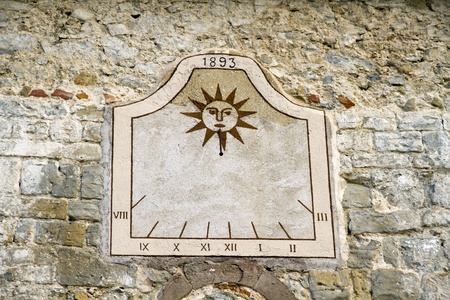 sundial old rustic wall of a Spanish villageの写真素材