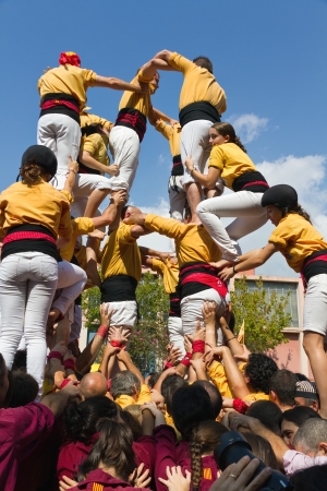 BARCELONA - SEPTEMBER 11  Some unidentified people called Castellers do a Castell or Human Tower, typical tradition in Catalonia, on September 11, 2012 in Barcelona, Spain のeditorial素材