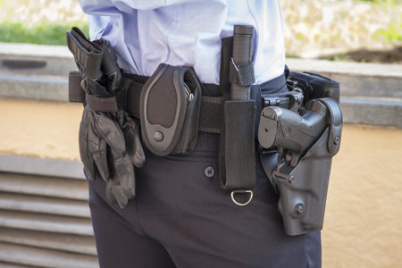 a police officer standing in the street next to his car  の写真素材