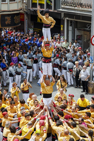 BADALONA, SPAIN- MAY 18, 2014: Some unidentified people called Castellers do a Castell or Human Tower, typical tradition in Catalonia. のeditorial素材