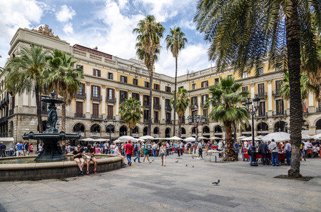 BARCELONA - JUNE 29, 2014: Tourists on Plaza Real in Barcelona, Spain. The Royal Plaza is a square in the Gothic Quarter. Located next to La Rambla and is a well-known tourist attraction. All holidays, collectors gather to buy stamps and coin collection.のeditorial素材