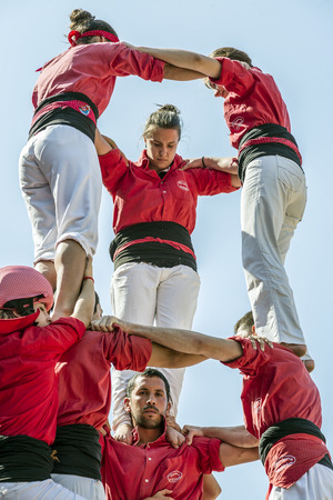 BADALONA, SPAIN - SEPTEMBER 11, 2014: Some unidentified people called Castellers do a Castell or Human Tower, typical tradition in Catalonia. Celebrating National Day the Catalan Nationalのeditorial素材