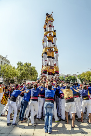 BADALONA, SPAIN - SEPTEMBER 11, 2014: Some unidentified people called Castellers do a Castell or Human Tower, typical tradition in Catalonia. Celebrating National Day the Catalan Nationalのeditorial素材