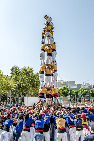 BADALONA, SPAIN - SEPTEMBER 11, 2014: Some unidentified people called Castellers do a Castell or Human Tower, typical tradition in Catalonia. Celebrating National Day the Catalan Nationalのeditorial素材