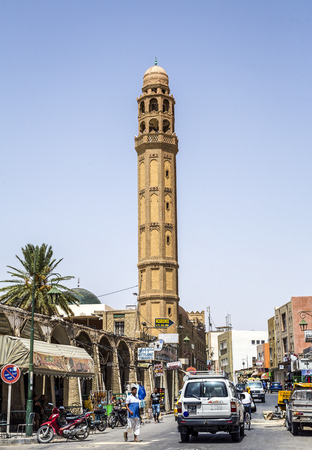 TOZEUR, TUNISIA - AUGUST 18, 2014: The el-Ferdous Tozeur Tunisia Mosque built with bricks ocher whose peculiar placement form geometrical designs that decorate the entire facade. Its towering minaret of 7 bodies.のeditorial素材