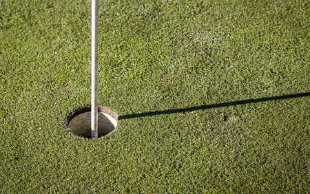 golf flag on green grassの写真素材