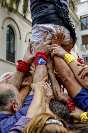 Badalona, Spain - May 13, 2018: Some unidentified people called Castellers do a Castell or Human Tower, typical tradition in Catalonia, Major festivals of the city.のeditorial素材