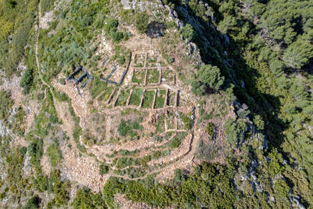 Tossal del Mortorum is an archaeological site located on a hill facing the coastal plain of Ribera de Cabanes, Castellon Spain aerial overhead viewの写真素材