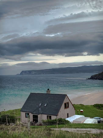 Inverness, Scotland - June 1,'2020: Beach house in Inverness, Scotland. Sea shore. Overcast sky. Beach. Small tides.のeditorial素材