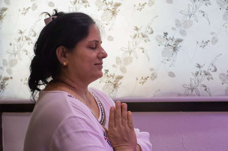 Indore, India - June 9,'2020: Indian/asian woman praying at home in coronavirus lockdown.のeditorial素材