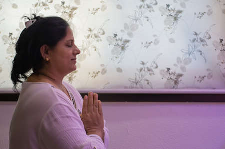 Indore, India - June 9,'2020: Indian/asian woman praying at home in coronavirus lockdown.のeditorial素材