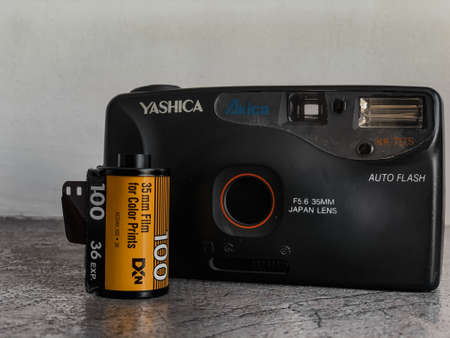 Indore, India - July 24,'2020: Yashica vintage reel camera with Kodak films.
Yashica Kr-717 S. Camera on grey surface and white background. 35mm lens.のeditorial素材