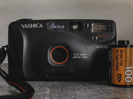 Indore, India - July 24,'2020: Yashica vintage reel camera with Kodak films.
Yashica Kr-717 S. Camera on grey surface and white background. 35mm lens.のeditorial素材