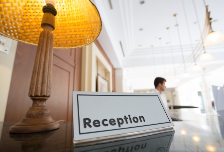 Hotel reception desk with a table and receptionists on a backgroundの写真素材