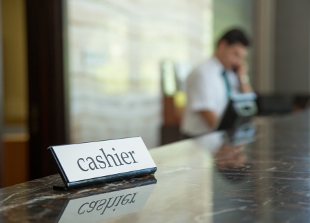 Hotel reception desk with a cashier table and receptionist on a backgroundの写真素材