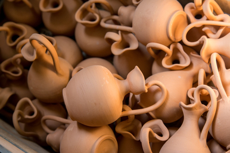 Box full of small brown clay  jars made by greek artistsの写真素材