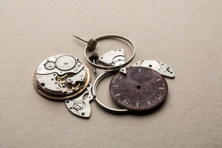 Clockwork spare parts. Metal gear, cogwheels, dial.