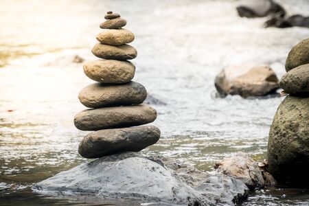 Balancing stones on a river rocks. Stability concept in a turbulence world
