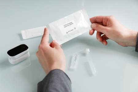 Hands holding covid-19 antigen rapid test set. Medical care conceptの写真素材