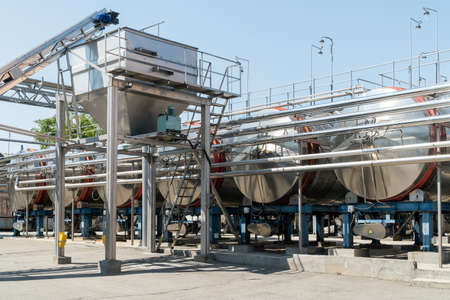 Stainless steel equipment for wine fermentation at a winery. Wine production industry concept.